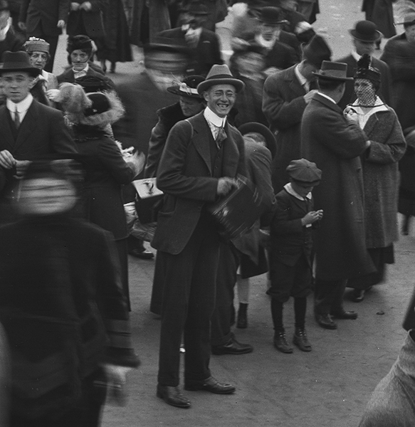 Grinning man with a box camera.