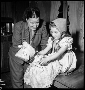 Bonney gives a young girl a doll during relief efforts in Ammerschwihr, France.