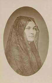 Bust portrait of young woman, identical to the daguerreotype portrait of Ana Maria de la Guerra wearing a lace mantilla, but portrait is a paper print on a card mount.